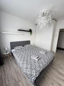 a bedroom with a bed and a chandelier at HomeSweetHome in Pärnu