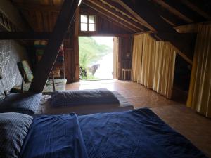 a bedroom with a bed and a large window at Doppelbett im Schlafraum einer Alphütte in Bisisthal +25 photos