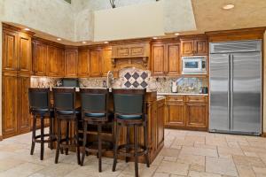 a kitchen with wooden cabinets and a stainless steel refrigerator at 12 Vail Road - Unit 8 in Vail