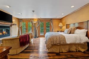 a bedroom with a large bed and a fireplace at 12 Vail Road - Unit 8 in Vail