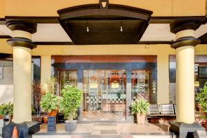 a store front of a building with a window at Dancenter S Hotel in Tanjunguma
