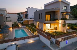 an aerial view of a house with a swimming pool at Diamond A1 Luxury Inn in Iraklitsa