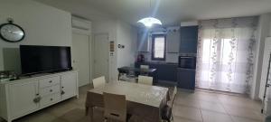 a kitchen with a table and a tv and a dining room at Casa vacanze Belvedere in Teramo