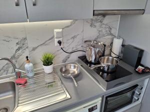 a kitchen with a sink and a counter top at Vaso's nest at Patras Center in Patra