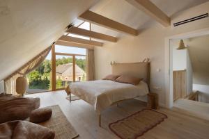 a bedroom with a bed and a large window at Dymnica 5 in Ulinia