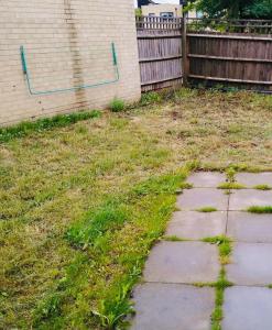 a yard with a fence and a stone walkway at Atom, Large 4 to 5 Bed House in East London, Sleeps 12, Garden, Parking, ideal for Contractors, Large Groups, Travellers in Barking