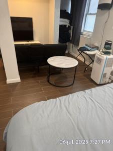 a room with a bed and a table and a couch at Studio Apt Lake Park Station Airport Hospital NJ NYC in Rahway