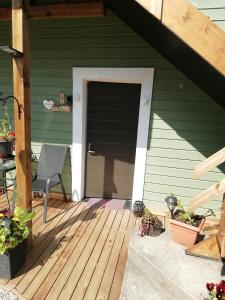 a door to a house with a deck at Lili stuudio in Otepää +16 photos