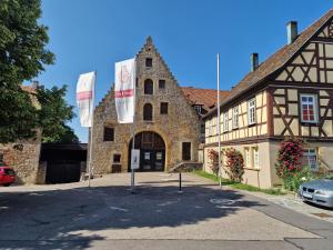 a building with flags in front of it at Hohenlohe -Residenz-Svetlana in Langenburg