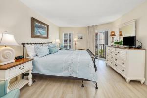 - une chambre avec un lit, une commode et une télévision dans l'établissement Beach Club #313, à Île de Saint-Simon 29 autres photos