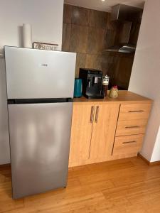 a stainless steel refrigerator in a kitchen with a counter at Apartman Stone Garden in Mostar