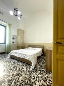 a bedroom with a bed in a room with a floor at Rifugio del Sole in Cutrofiano