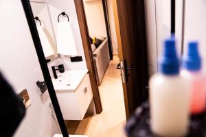 a bathroom with a sink and a mirror at R102-3-4 Amazing apartments in Belvedere with Breathtaking Ocean and Street Views in Casablanca +95 photos