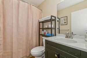 a bathroom with a sink and a toilet at Kings, 75" TV & Backyard Fun - NearWesley in The Dell +25 photos