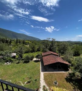 a building with a roof on top of a field at Dali`s Guest House in Lebach'e