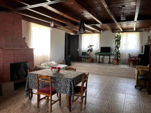 a living room with a table and chairs and a fireplace at Dali`s Guest House in Lebach'e