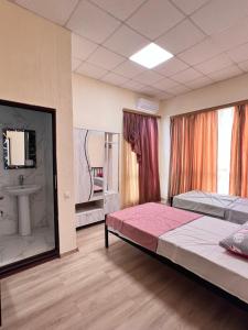 a hotel room with two beds and a sink at Hotel Egrisi in Senaki in Senaki