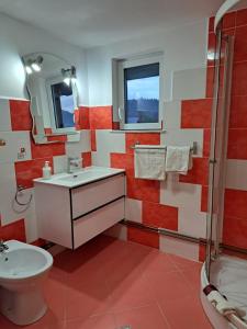 a red and white bathroom with a sink and a shower at Casa Sofia in Vama +22 photos