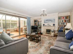 a living room with two couches and a fireplace at Melita in Langport