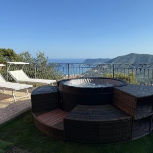 a patio with a fire pit and two chairs at Domus Luxury villa Alassio in Alassio +26 photos