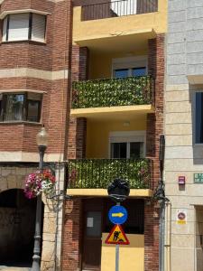 a building with two balconies and a street sign at Loft Capadocia 1A in Vinarós