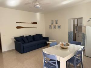 a living room with a blue couch and a table at Il Piccolo Giardino in Levanto