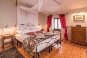 a bedroom with a large bed with red curtains at Holiday home in Merisce - Istrien 53394 in Merišće +42 photos