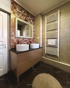 a bathroom with two sinks and a mirror at Apartments Velickovic in Soko Banja +81 photos