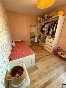 a small bedroom with a bed and a dresser at Cocon avec jacuzzi in Périgny +8 photos