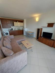 a living room with a couch and a table at Lozenets Oasis Beach Home Four in Lozenets