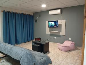 a hospital room with a bed and a flat screen tv at Aires de Mendoza in Maipú