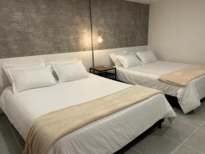 Postel nebo postele na pokoji v ubytování Hotel 79 Poblado