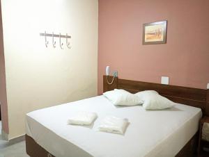 a bedroom with a bed with two white pillows at Hotel Faf's Interlagos - SP in Sao Paulo