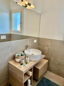 a bathroom with a sink and a mirror at Residenza Bramante 3 in Olbia