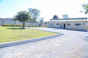 a house with a driveway in front of it at Forest Views Haven - Flat 2 in Solwezi
