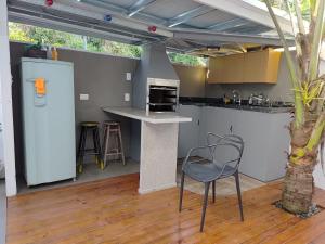 a kitchen with a counter and a chair in a room at Mata Atlântica Apart Container in Joinville