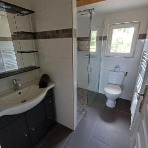 a bathroom with a toilet and a sink and a shower at Ciotat t3 piscine in La Ciotat