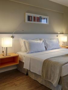 Cama ou camas em um quarto em Intercity BH Expo