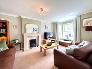 a living room with a couch and a fireplace at Harefield in Morpeth