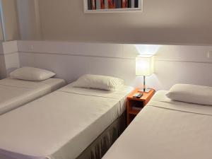 Cama ou camas em um quarto em Intercity BH Expo