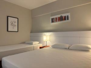 Cama ou camas em um quarto em Intercity BH Expo