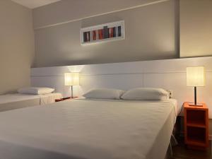 Cama ou camas em um quarto em Intercity BH Expo