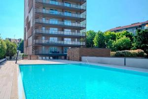 a large swimming pool in front of a building at Giax Tower-Spa, Pool, Parking in Milan
