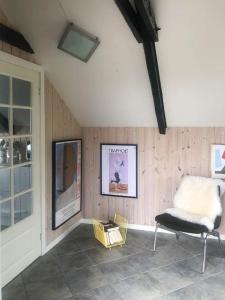 a living room with a chair and a table at Holiday Home With Sea Views Over The Western Sea in Vestervig +19 photos
