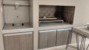 a kitchen with a sink and a fireplace at LOS NARANJOS in Reconquista +12 photos
