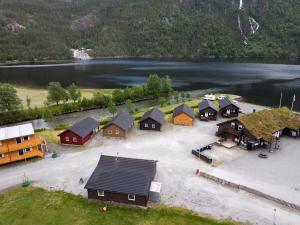an aerial view of a group of houses next to a lake at Family Cabins in Fjæra +8 photos