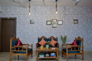 a living room with two chairs and a table at City Central Hostel in Kolkata