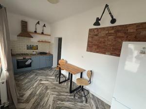 a kitchen with a wooden table and chairs in it at Airport Green 2 in Cluj-Napoca