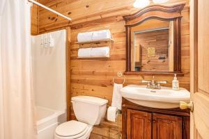 Un baño con inodoro, lavabo y espejo. en River Fishing Cabin, en Lakemont 40 fotos más