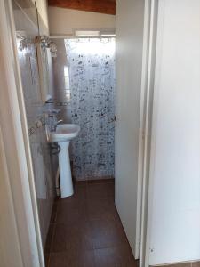 a bathroom with a sink and a toilet and a shower at Chalets du lac in Capilla del Monte